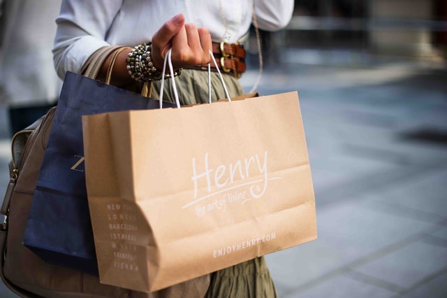 a woman taking a shopping bag